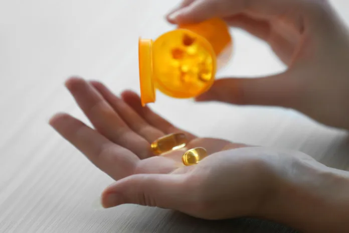 Woman Taking Vitamin D Supplements Doctors Warn of Serious Winter Vitamin D Deficiency