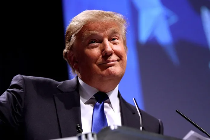 Donald Trump speaking at a podium during a public event.