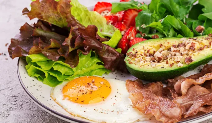 Protein and ageing: A healthy meal with egg, avocado, bacon, leafy greens and berries, highlighting protein-rich foods linked to healthy ageing.