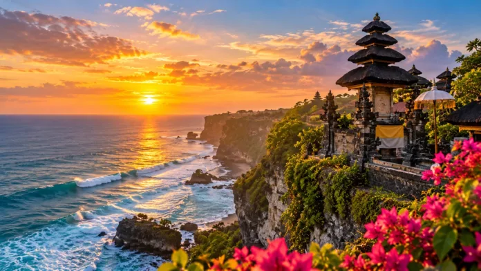 Balinese temple perched on a dramatic coastal cliff overlooking the Indian Ocean at golden sunset, with tropical greenery and crashing waves in Bali, Indonesia.